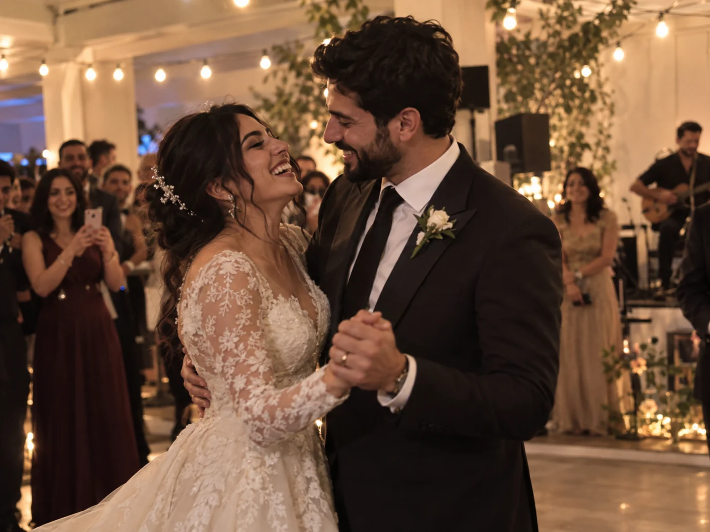 A guest's candid phone photo of a bride and groom smiling during their first dance